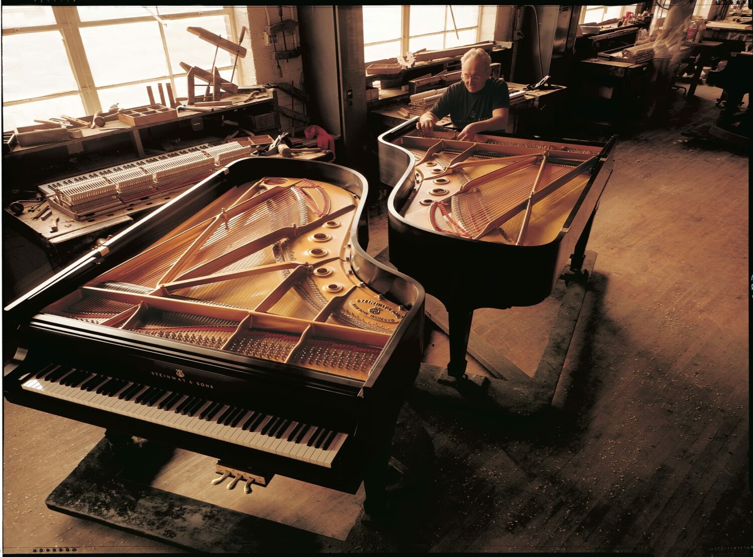 Photo of two Steinway grand pianos in factory