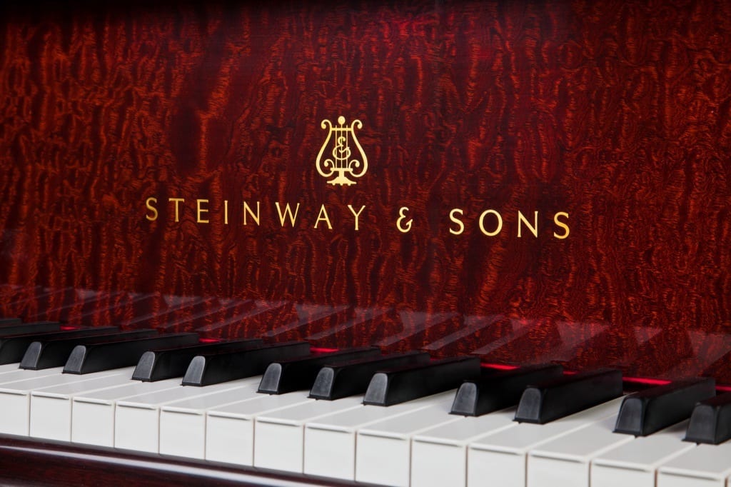 Photo of Steinway & Sons logo on mahogany grand piano