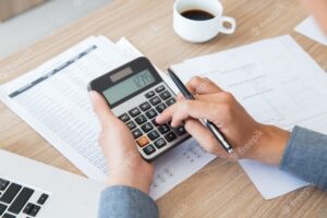 Photo of person working on a calculator