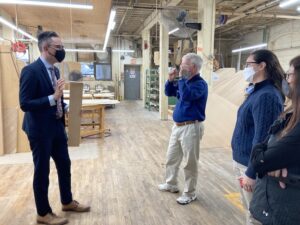 People discussing Steinway piano production at the Steinway factory
