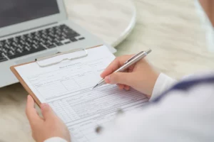 Picture of person with a sign-up sheet
