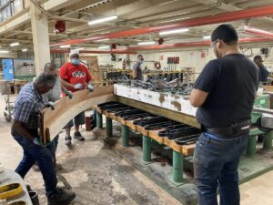 Steinway workers bending the rim on a grand